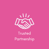 A pink square with a white image of two hands clasped together signifying partnership